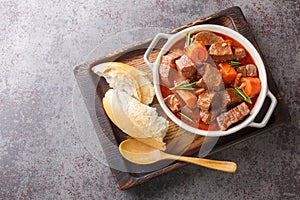 Daube de Boeuf Provencale slow cooked Rich Beef Stew closeup in the wooden tray. Horizontal top view