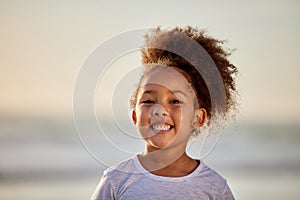 A daughter is a bundle of firsts that excite. an adorable little girl having fun on the beach.