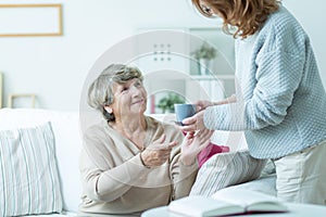 Daughter caring about elder mother photo