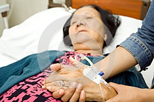 Daughter caring sick elderly mother photo