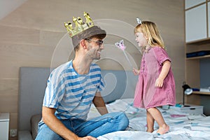 Daughter casting spell on father with magic wand