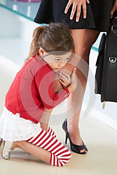 Daughter Clinging To Mother's Leg