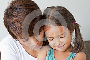 Daughter comforted by her caring mother photo