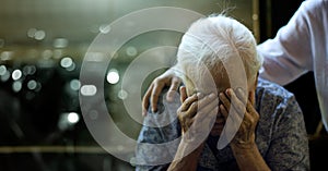 The daughter is comforting an elderly woman who is a mother sadness with Alzheimer`s disease and amnesia, Memory loss due to