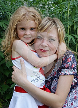 Daughter embraces mother in the park