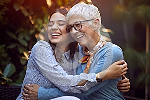 Daughter embracing her smiling mother