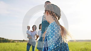 daughter with family in the park. happy family walk in the park on green grass in nature. parents and children walk in