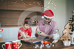 Daughter and father baking Christmas cookies
