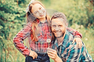 Daughter and father with dandelion. spring village country. ecology. Happy family day. little girl and happy man dad