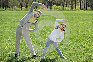 daughter and father doing physical exercise