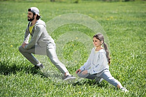 daughter and father doing physical exercise