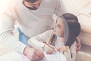 Daughter and father making a present for mom