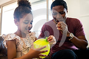 Daughter and father playing together at home. photo