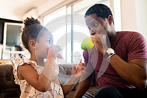 Daughter and father playing together at home. photo