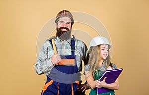 Daughter and father repairing together in workshop. Fatherhood. Bearded man with little girl. engineering education