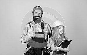 Daughter and father repairing together in workshop. Fatherhood. Bearded man with little girl. engineering education