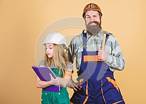 Daughter and father repairing in workshop. Bearded man with little girl. engineering education. construction worker