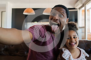 Daughter and father taking a selfie at home. photo