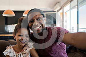 Daughter and father taking a selfie at home. photo