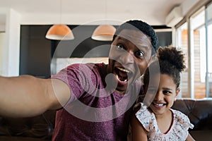 Daughter and father taking a selfie at home. photo