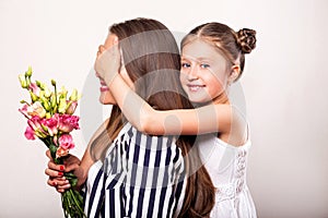 Daughter gives flowers to her mother on her mother`s day