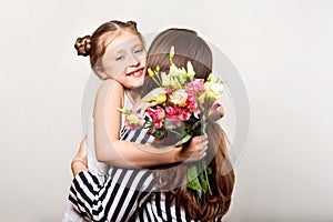 Daughter gives flowers to her mother on her mother`s day