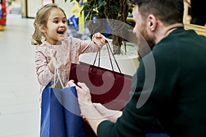 Daughter gives her dad bags full of shopping