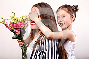 Daughter gives her mother flowers in the studio, happy mother`s