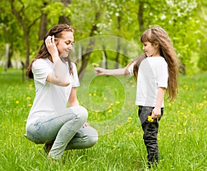 The daughter gives to mother a dandelion