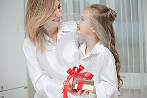 Daughter giving her mother a christmas present