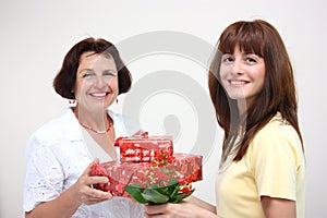 A daughter giving her mother presents