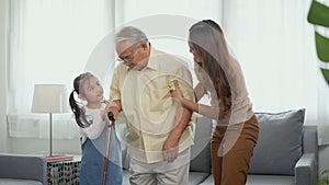 Daughter and granddaughter take care support grandfather who is suffering from knee pain Got walking