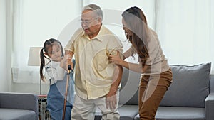 Daughter and granddaughter take care support grandfather who is suffering from knee pain Got walking