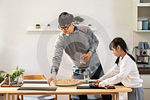 Daughter help dad prepare dining table