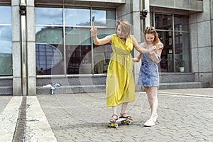 Daughter helping mum on skateboard