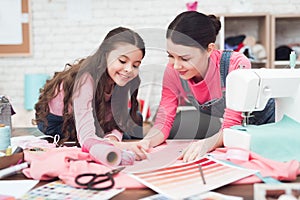 Daughter helps mom with work.