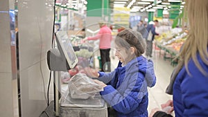 The daughter and her mother are shopping at the supermarket. Little assistant mistress