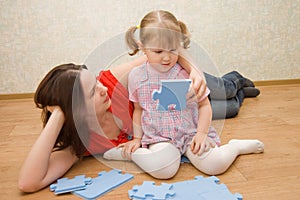 Daughter and her mother are solving puzzle