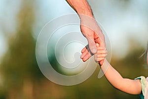 Daughter holds dad& x27;s hand