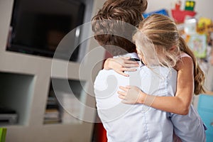 Daughter Hugging Father Returning From Work