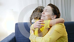 daughter hugs mom. happy family a lockdown stay home concept. mom and daughter hugging happy family. daughter takes care