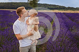 the daughter kisses her father. family picnic on a lavender field