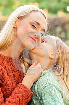 Daughter kisses her young mother