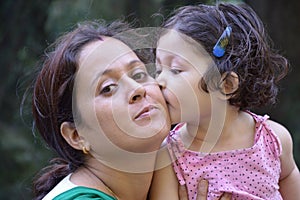 Daughter kissing her mother