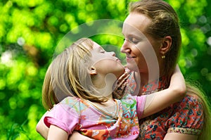 Daughter kissing her mum