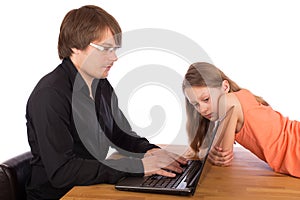 Daughter looks at her father's laptop