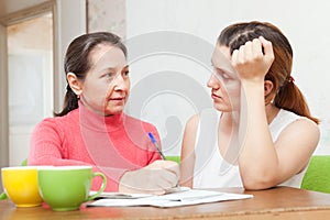 Daughter with mature mother fills in the documents