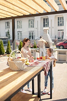 Daughter and mom getting the table ready for dinner