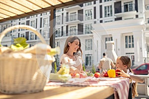 Daughter and mom sitting at the table before dinner