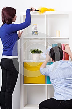 Daughter and mother during dusting